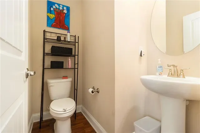 a bathroom with a toilet sink and mirror