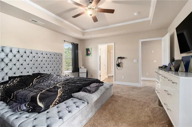 a bed room with a bed and a television