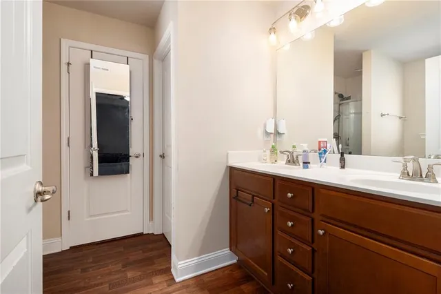 a bathroom with a double vanity sink and mirror