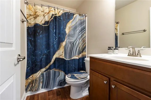 a bathroom with a sink a toilet and a mirror