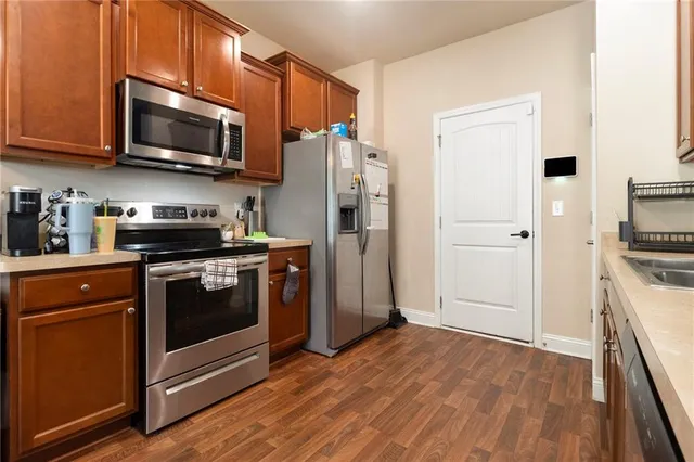 a kitchen with stainless steel appliances a refrigerator stove and microwave