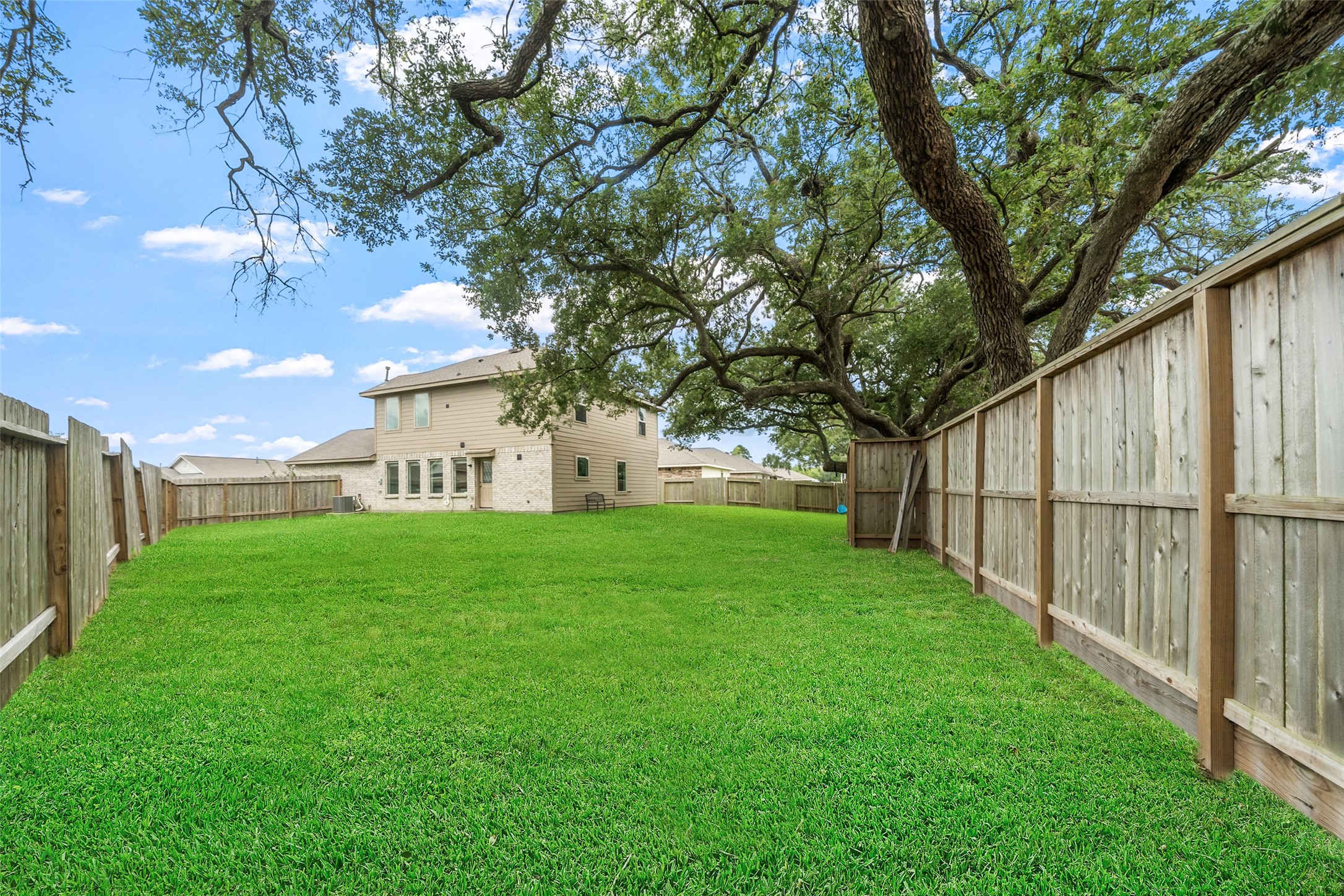 234 Bennett Street Angleton, TX 77515 - Photo 27 of 33 Look at this fabulous oak tree behind the fence. Enjoy the branches that sprawl into the backyard.