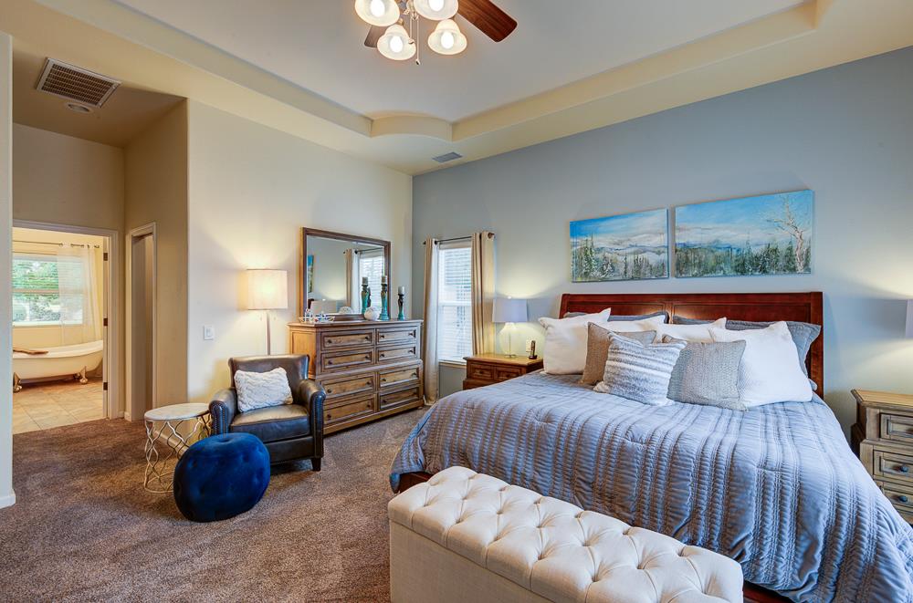17465 Monreal Road Madera, CA 93636 - Photo 32 of 59 a bedroom with a bed and a couch