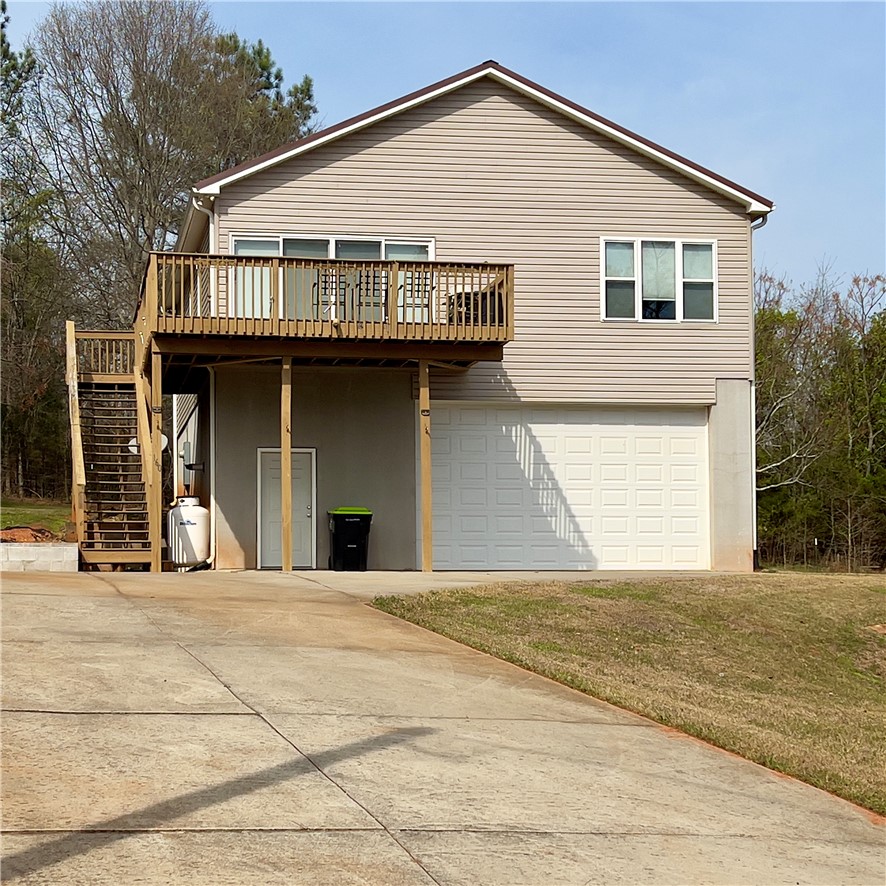 160 Hudgins Lake Road Townville, SC 29689 - Photo 1 of 41 A split-level residence with durable vinyl siding and a functional deck with external stairs.