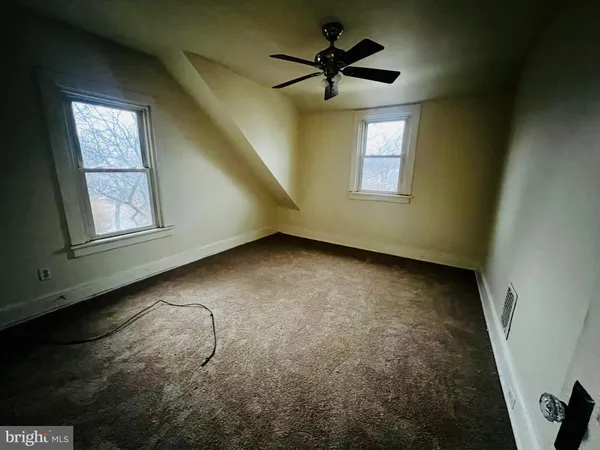 a view of deck with wooden floor and fence and a bench