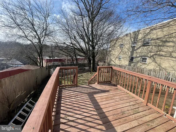 a view of deck with a large trees