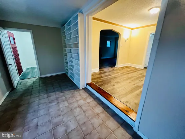 a view of a room with wooden floor and a window