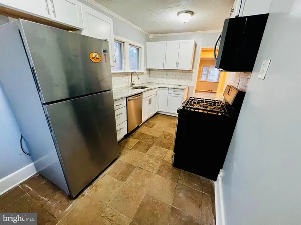 a kitchen with a sink and a stove top oven
