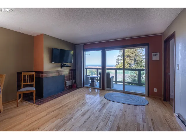 a living room with furniture wooden floor and a window