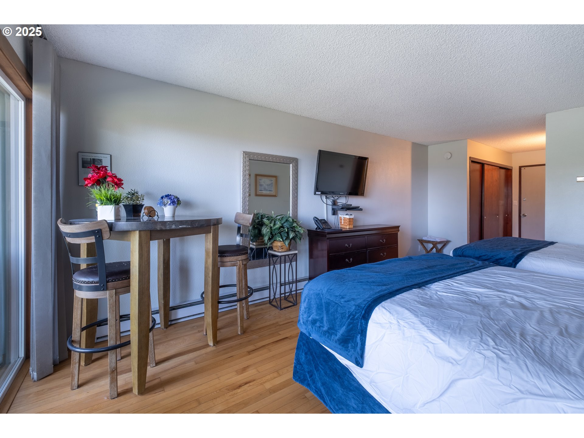 301 Otter Crest Loop, Unit 174/175 Otter Rock, OR 97369 - Photo 16 of 46 a bedroom with a bed and a flat screen tv