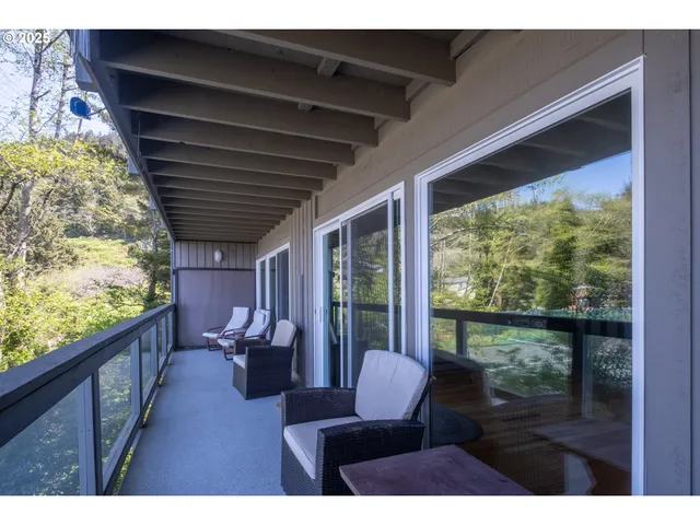 a balcony with wooden floor and furniture