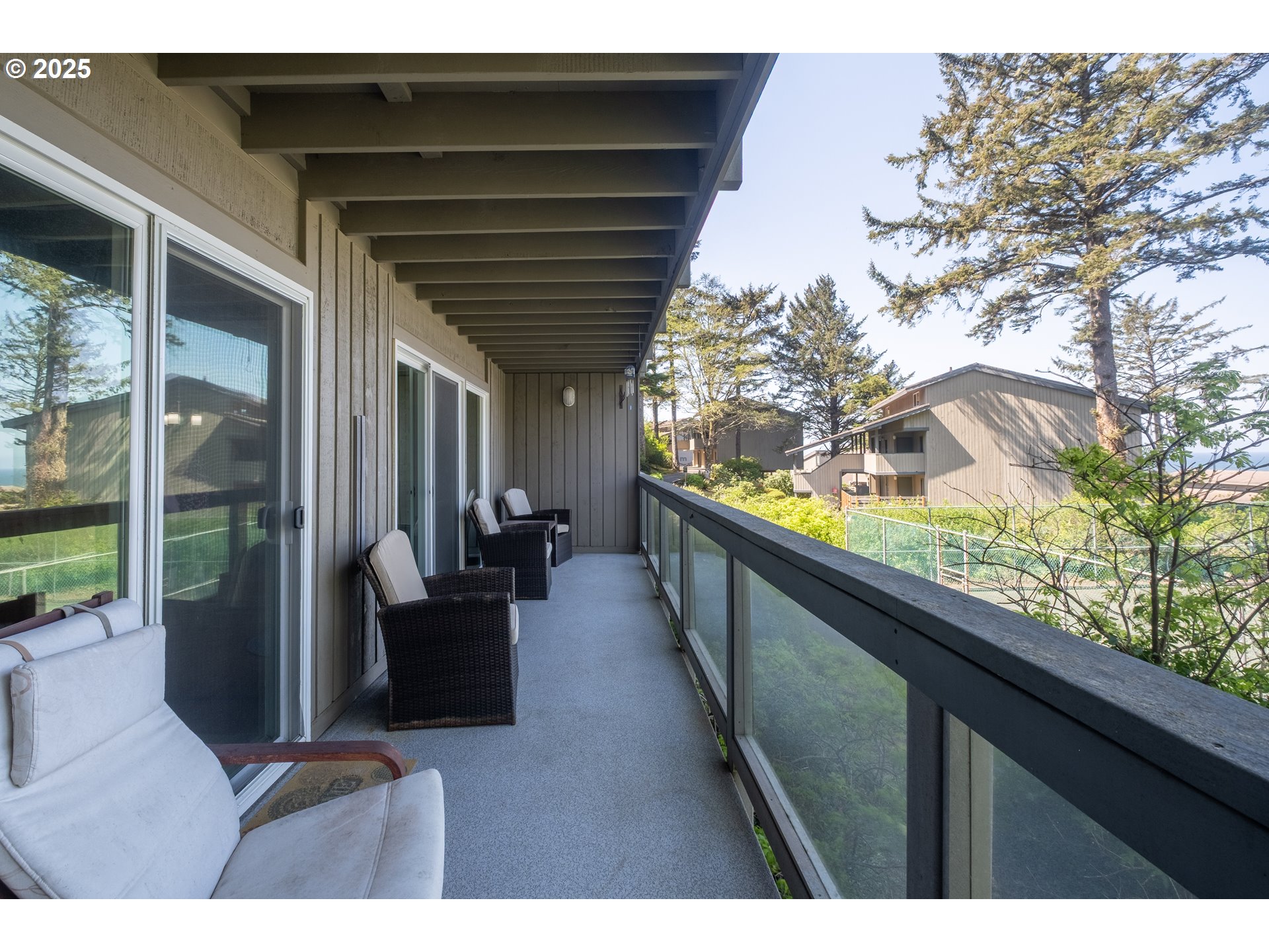 301 Otter Crest Loop, Unit 174/175 Otter Rock, OR 97369 - Photo 21 of 46 a balcony with wooden floor and furniture