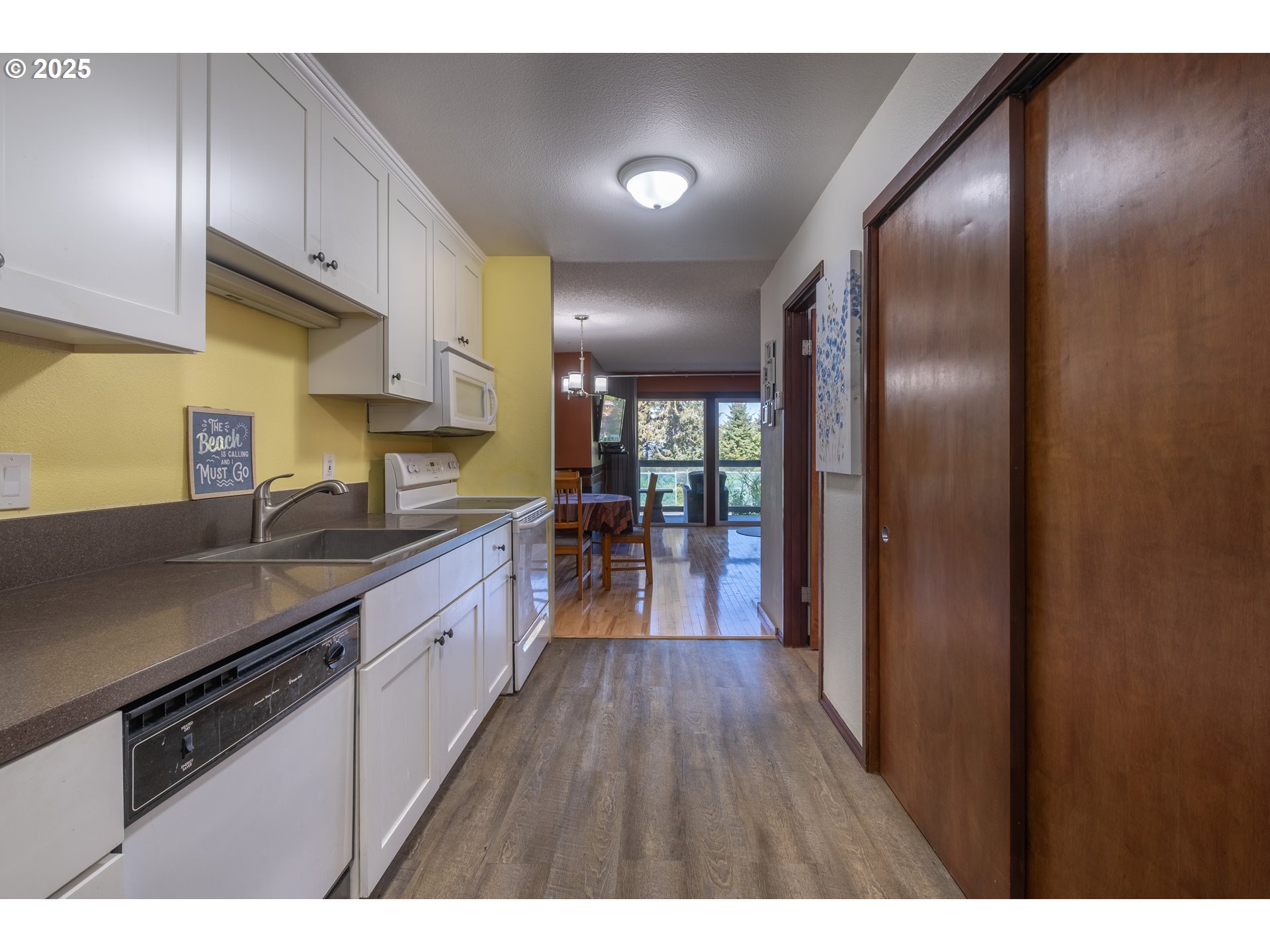 301 Otter Crest Loop, Unit 174/175 Otter Rock, OR 97369 - Photo 3 of 46 a large kitchen with granite countertop a large counter top space a sink stainless steel appliances and cabinets