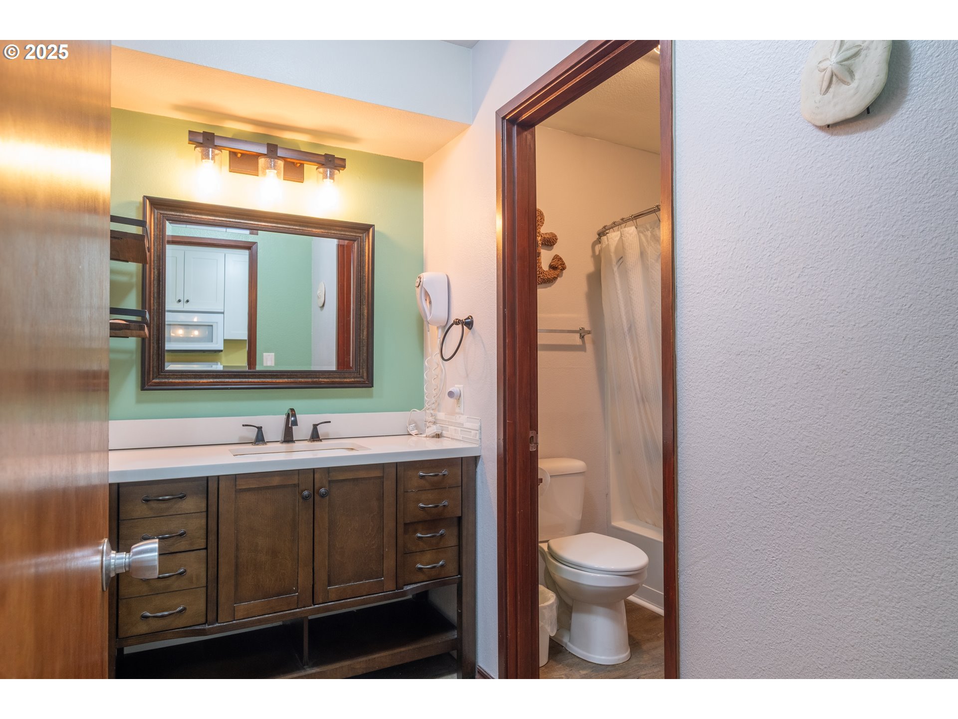 301 Otter Crest Loop, Unit 174/175 Otter Rock, OR 97369 - Photo 6 of 46 a bathroom with a toilet a sink a mirror and vanity