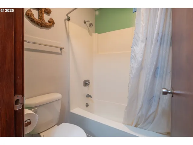 a bathroom with a shower and toilet
