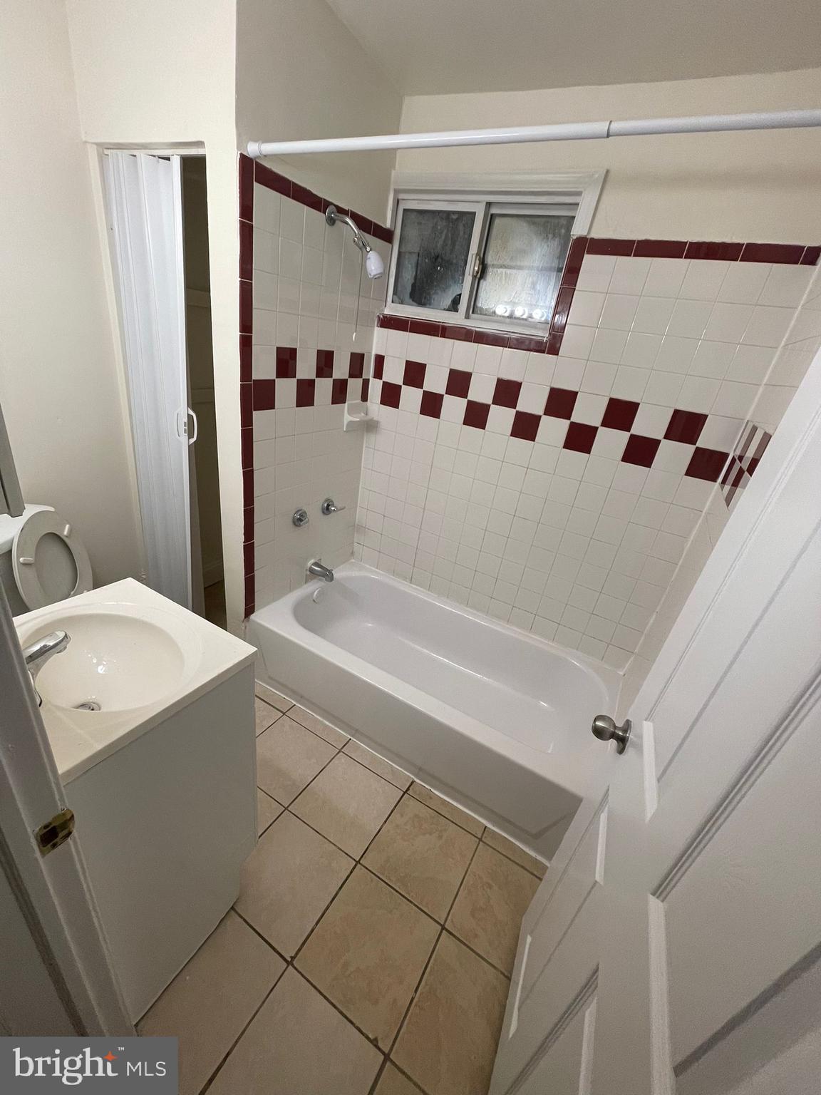 202 Harmison Street Baltimore, MD 21223 - Photo 11 of 16 a bathroom with a tub sink and mirror