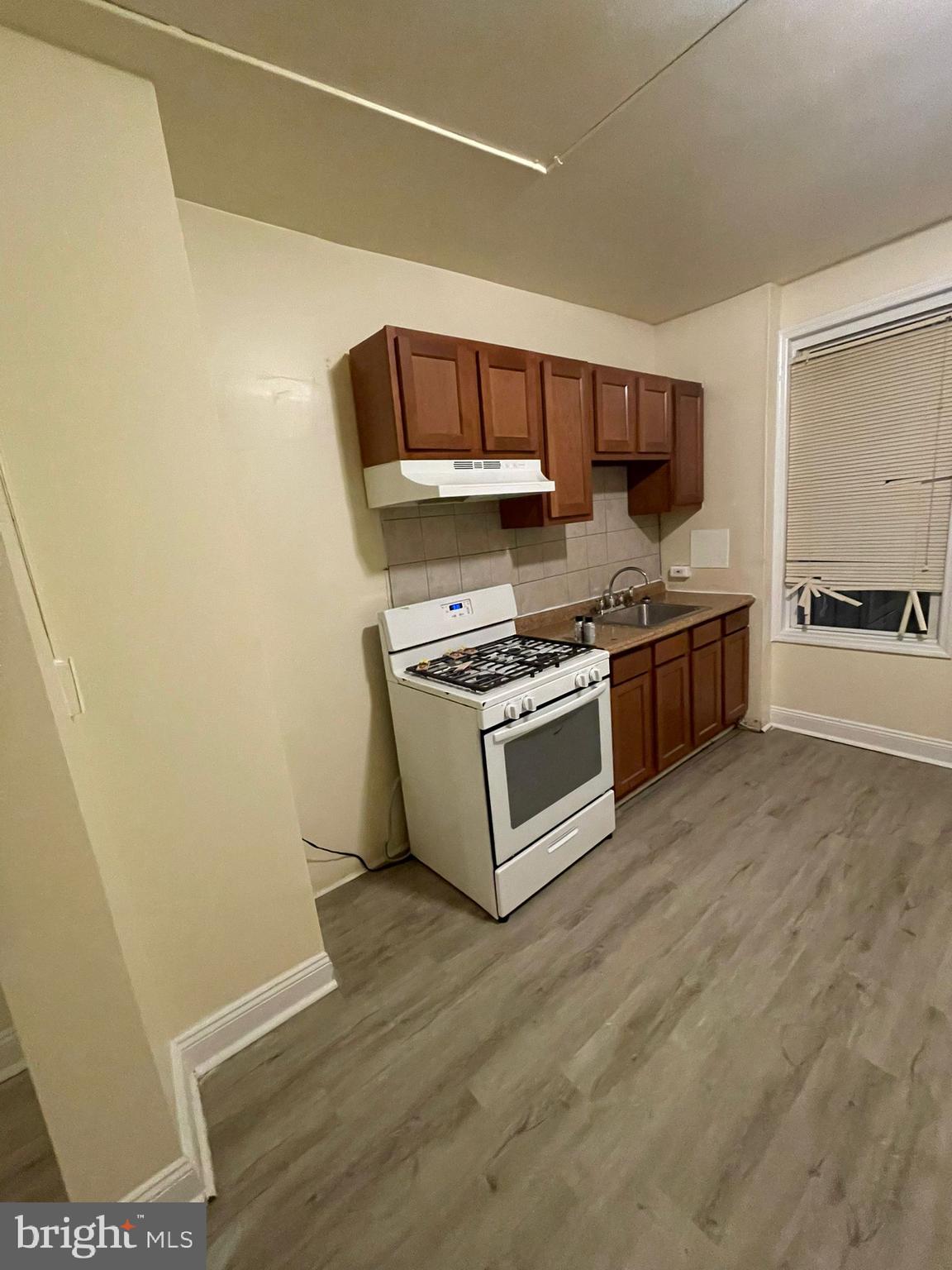 202 Harmison Street Baltimore, MD 21223 - Photo 4 of 16 a kitchen with stainless steel appliances a stove a sink and a refrigerator
