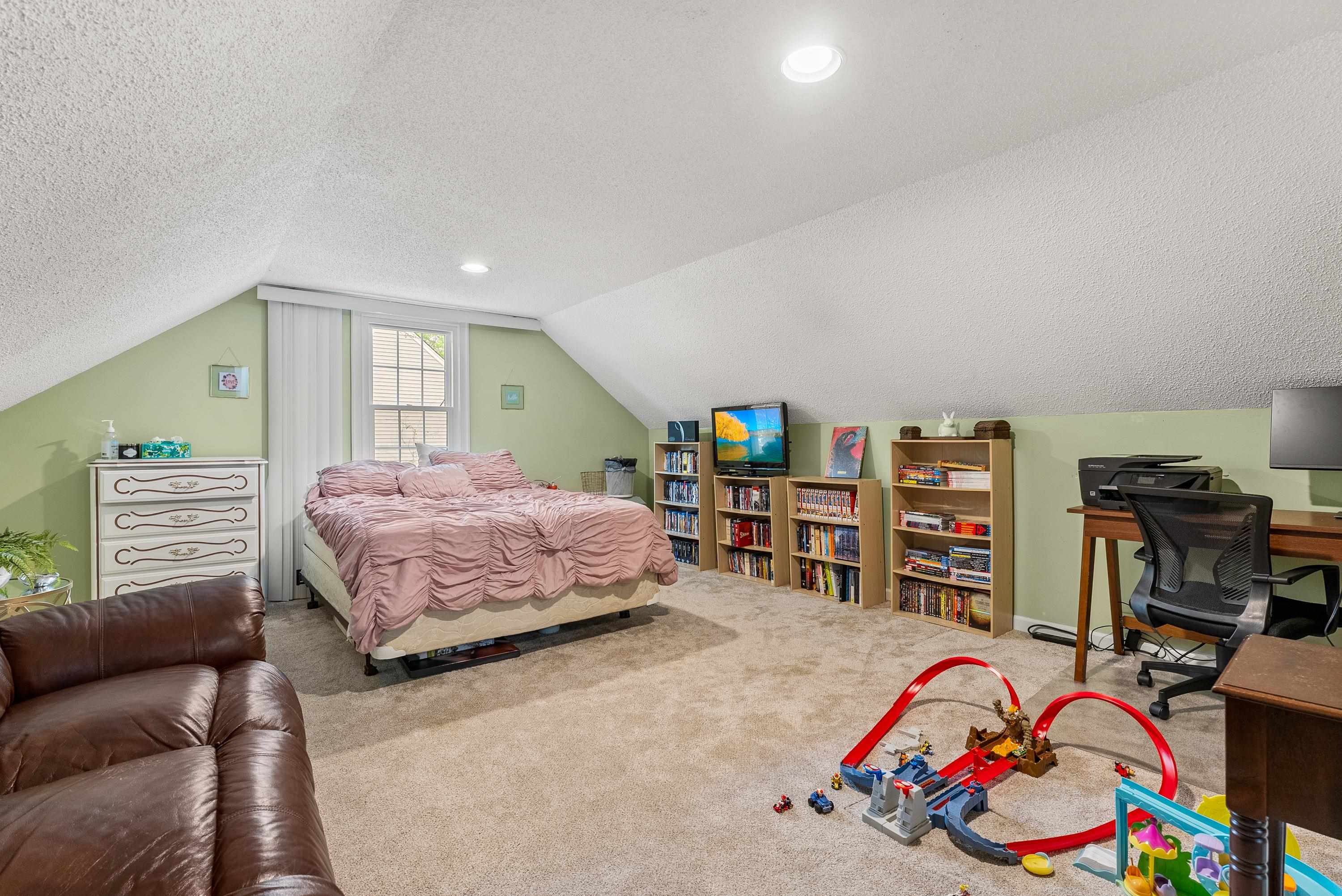 182 East Powell Road Collierville, TN 38017 - Photo 15 of 21 a bedroom with a bed and a wooden floor