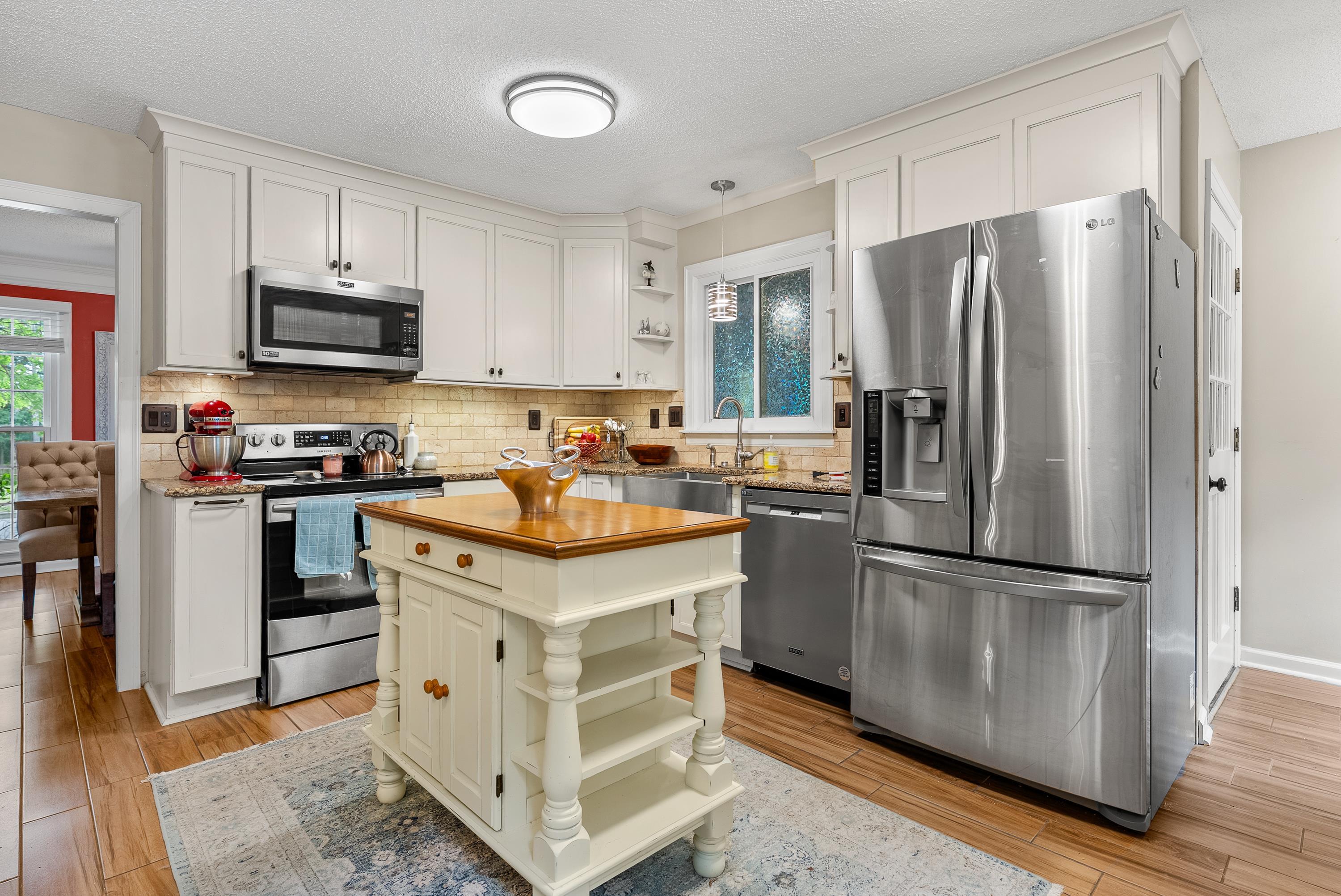 182 East Powell Road Collierville, TN 38017 - Photo 3 of 21 a kitchen with stainless steel appliances granite countertop a refrigerator a stove a sink and a refrigerator