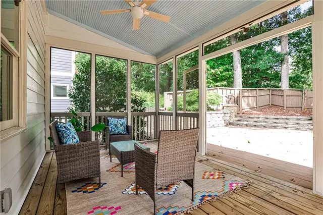 a living room with furniture and a floor to ceiling window