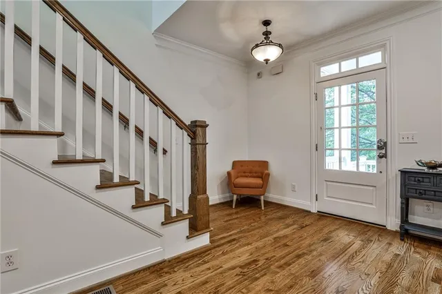 a living room with chairs and a wooden floor