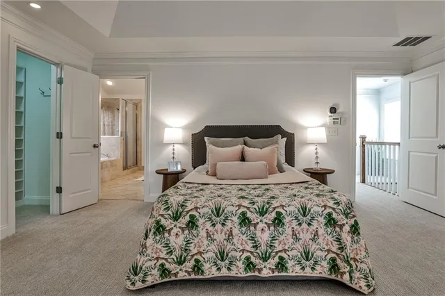 a bedroom with a bed and a refrigerator