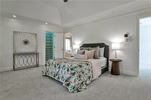 a bed room with a bed and two large window