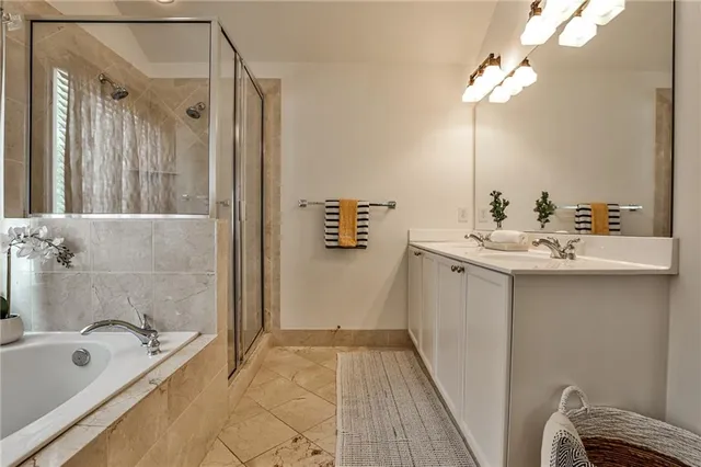 a bathroom with a tub sink and mirror
