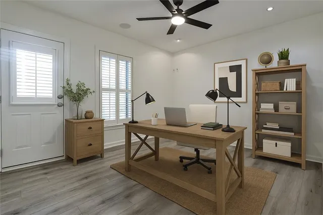 a view of a workspace with furniture and window