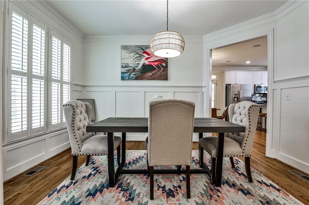 1621 Duncan Drive Northwest Atlanta, GA 30318 - Photo 7 of 53 a view of a dining room with furniture a chandelier and wooden floor