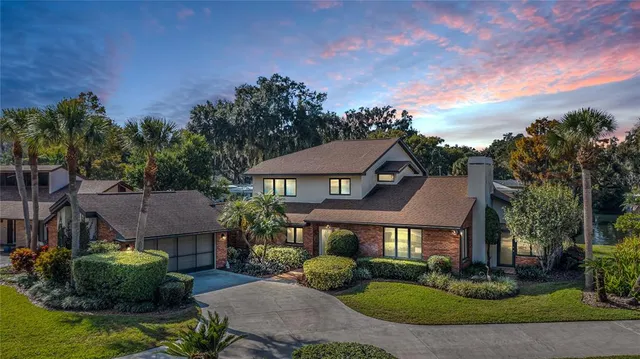 a view of a big house with a big yard and potted plants
