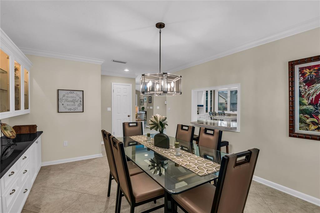 104 Acacia Point Yalaha, FL 34797 - Photo 12 of 83 a view of a dining room with furniture a chandelier and wooden floor