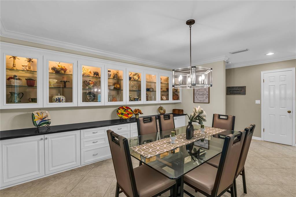 104 Acacia Point Yalaha, FL 34797 - Photo 13 of 83 a dining room with furniture a chandelier and window