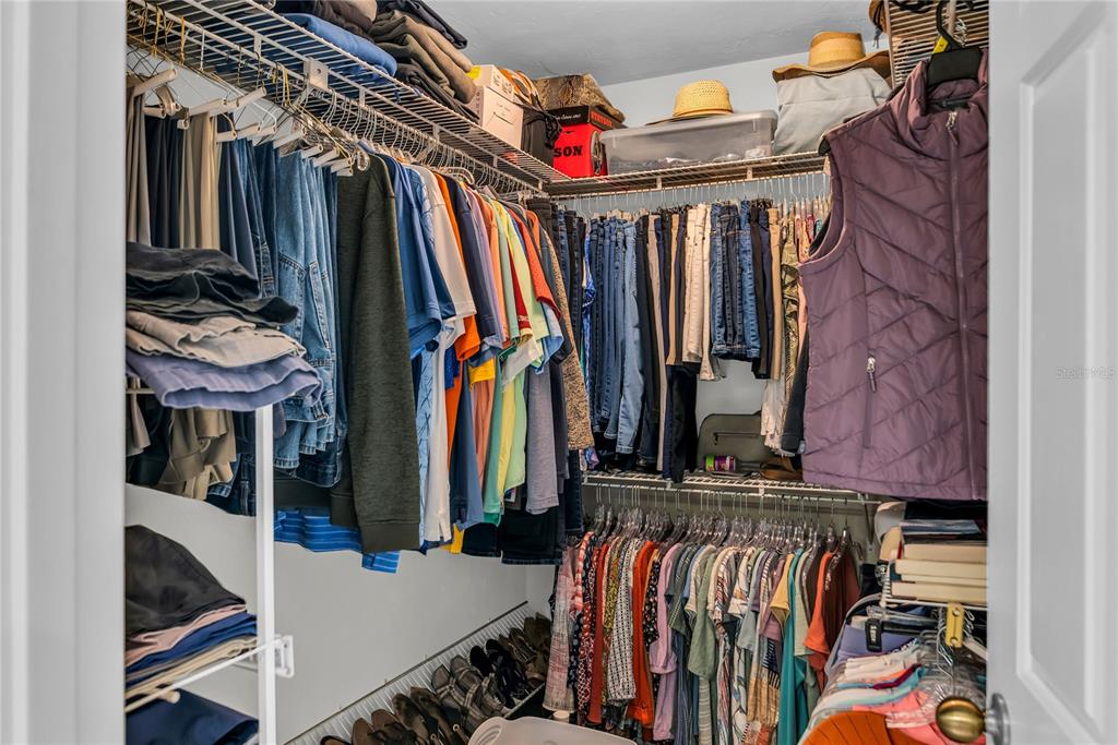 104 Acacia Point Yalaha, FL 34797 - Photo 22 of 83 a view of walk in closet with clothes and shoes