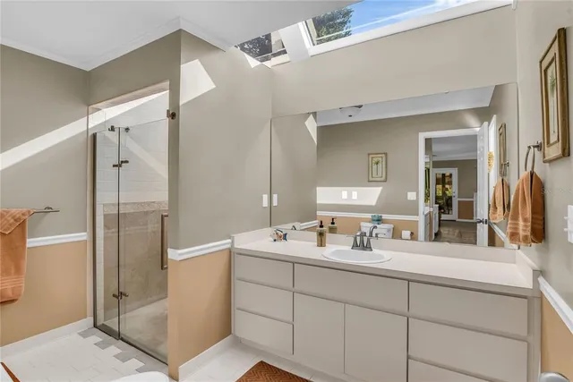 a view of staircase with lots of frames on wall and a window