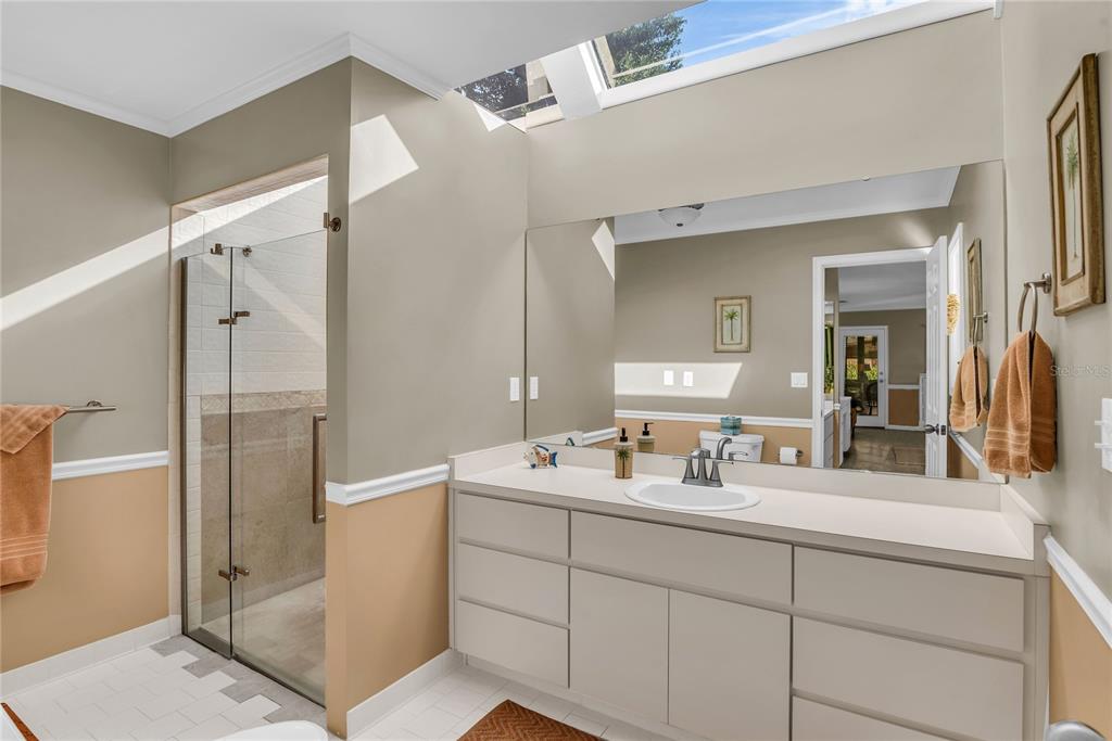 104 Acacia Point Yalaha, FL 34797 - Photo 23 of 83 a bathroom with a double vanity sink mirror and shower