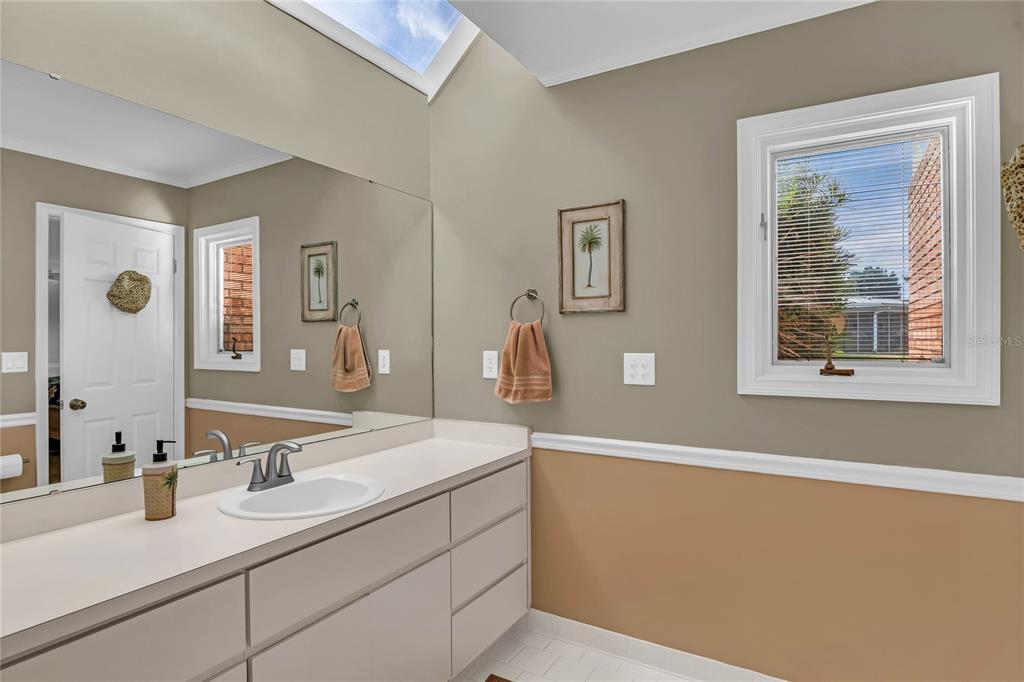 104 Acacia Point Yalaha, FL 34797 - Photo 24 of 83 a bathroom with a sink and a mirror