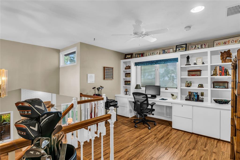 104 Acacia Point Yalaha, FL 34797 - Photo 26 of 83 a view of a livingroom with workspace and a window