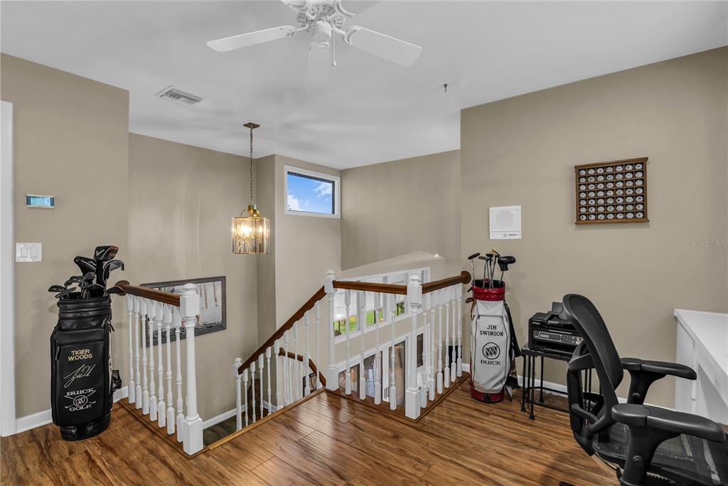 104 Acacia Point Yalaha, FL 34797 - Photo 27 of 83 a view of a hallway with workspace and wooden floor