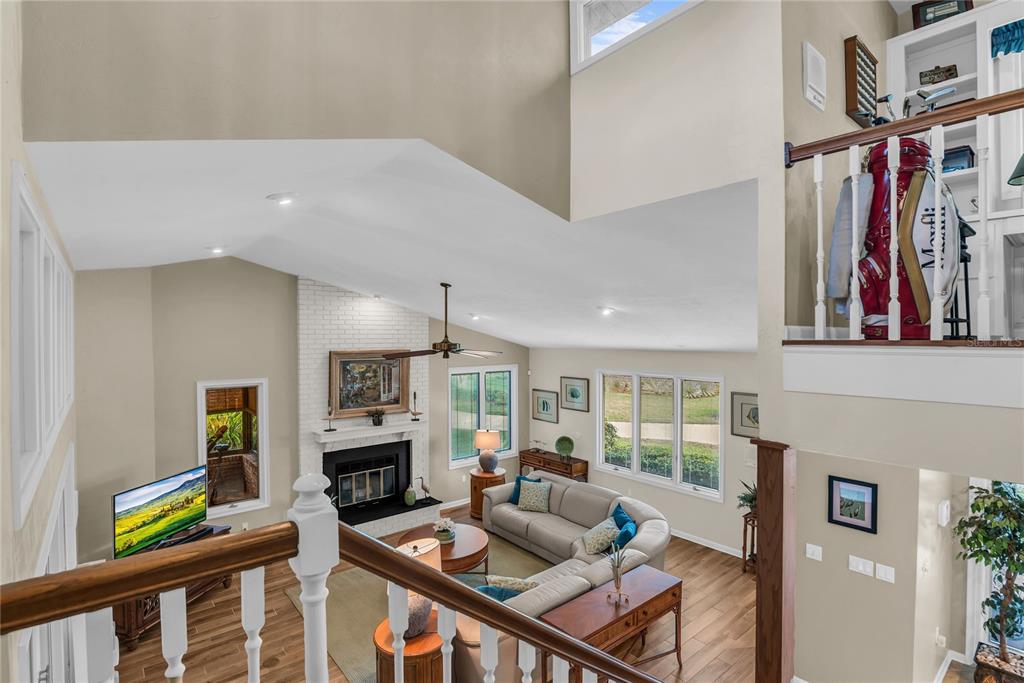 104 Acacia Point Yalaha, FL 34797 - Photo 28 of 83 a living room with furniture a fireplace and a large window
