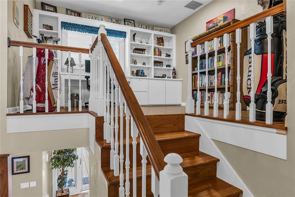 104 Acacia Point Yalaha, FL 34797 - Photo 29 of 83 a view of staircase with lots of frames on wall and a window