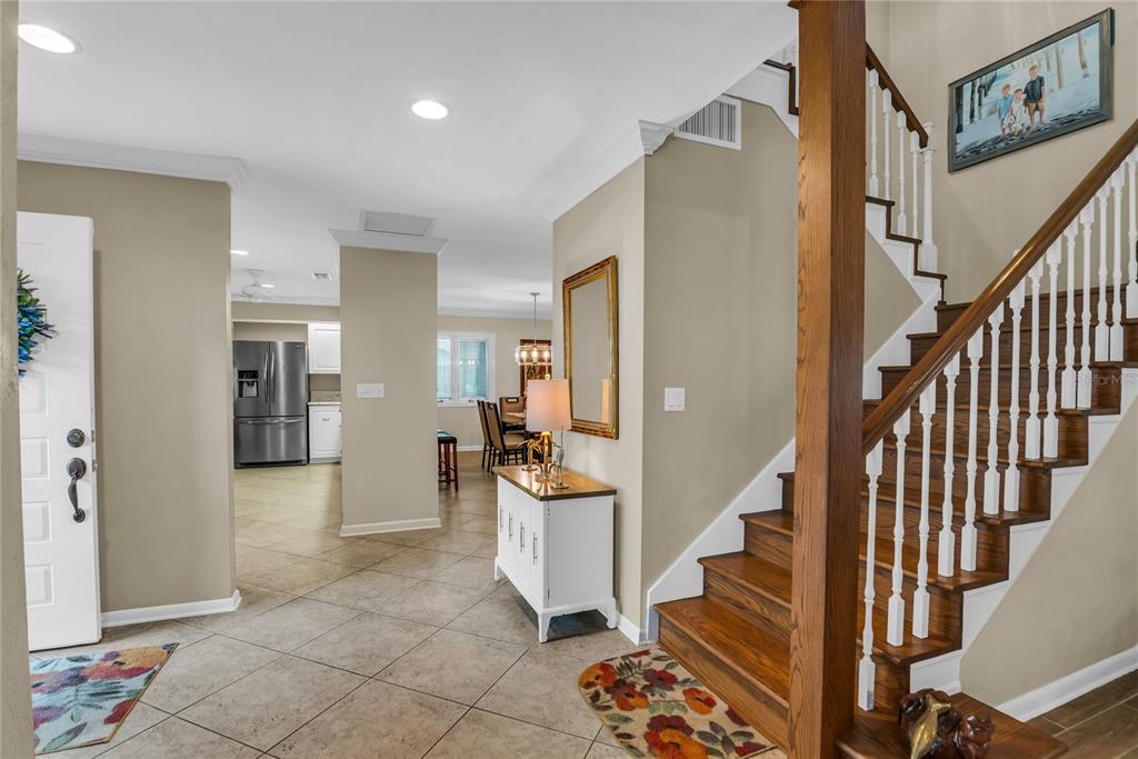 104 Acacia Point Yalaha, FL 34797 - Photo 30 of 83 a view of a hallway with wooden floor and staircase