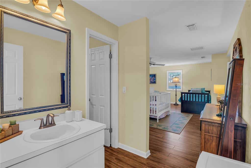 104 Acacia Point Yalaha, FL 34797 - Photo 35 of 83 a en suite bathroom with sink and mirror