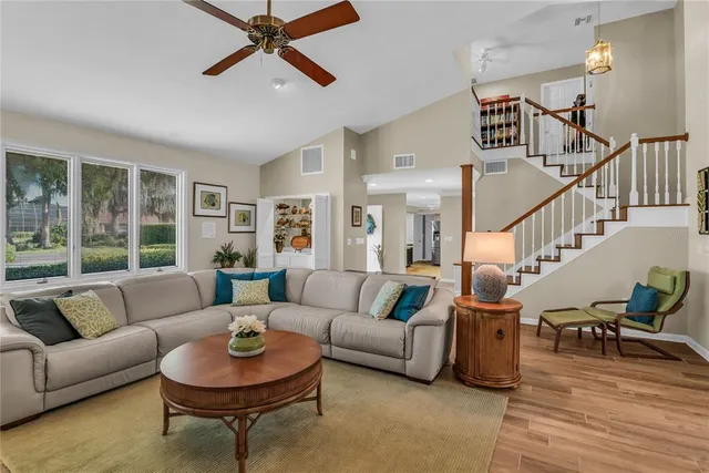 a kitchen with granite countertop kitchen island stainless steel appliances a stove a sink a refrigerator counter tops and a view of living room