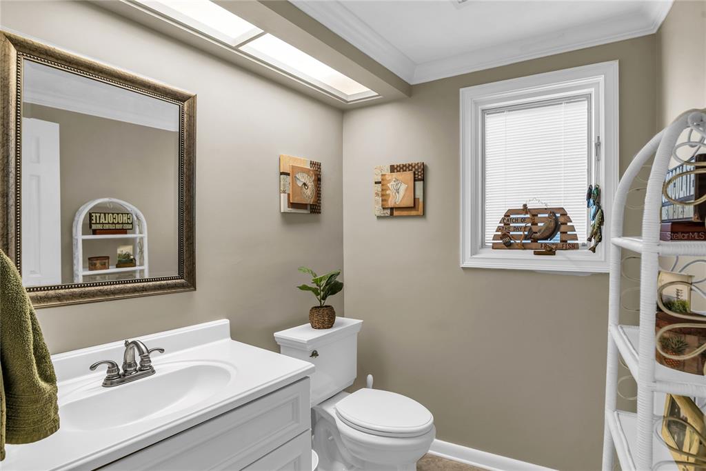 104 Acacia Point Yalaha, FL 34797 - Photo 45 of 83 a bathroom with a toilet a sink and mirror