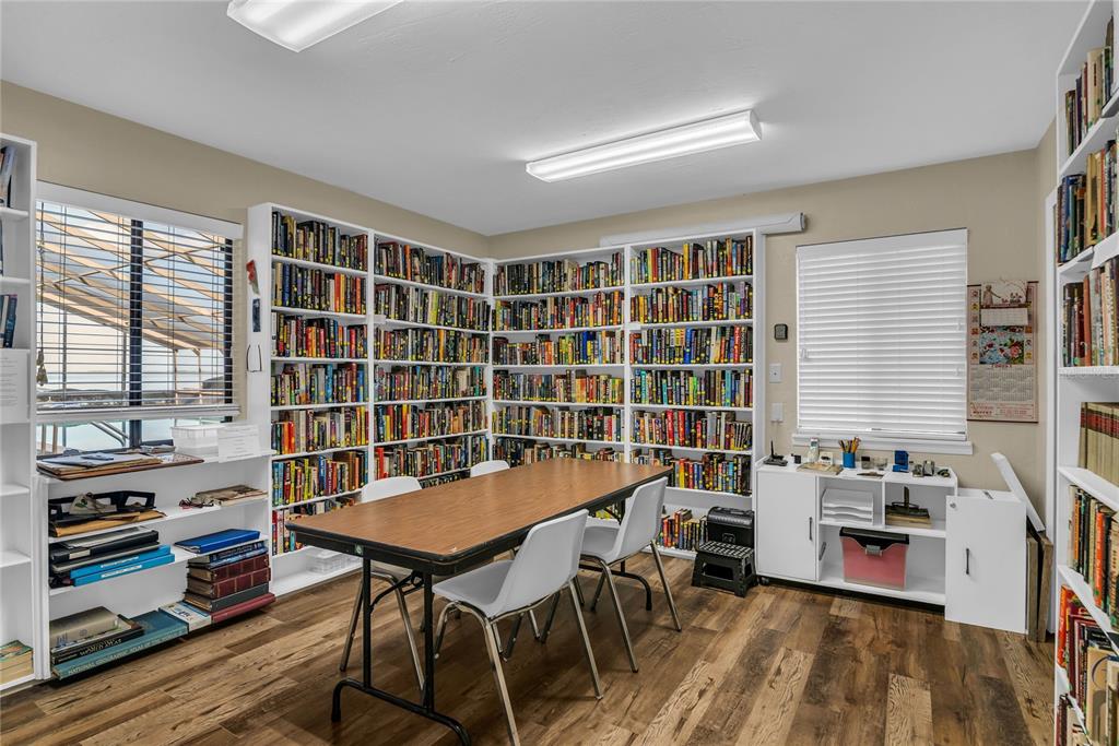 104 Acacia Point Yalaha, FL 34797 - Photo 50 of 83 a view of a workspace with furniture and a bookshelf