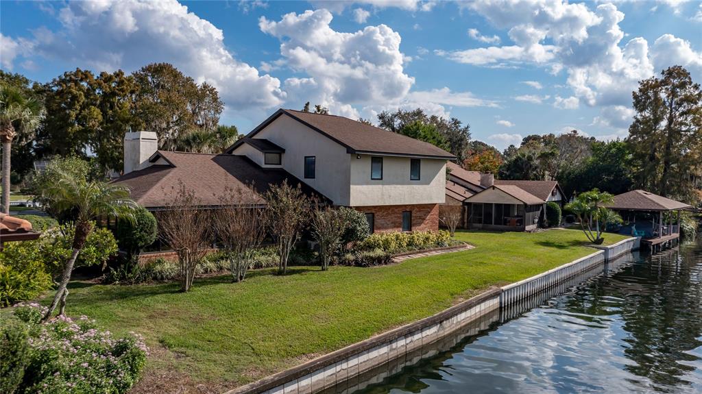 104 Acacia Point Yalaha, FL 34797 - Photo 52 of 83 a view of a big house with a big yard and potted plants