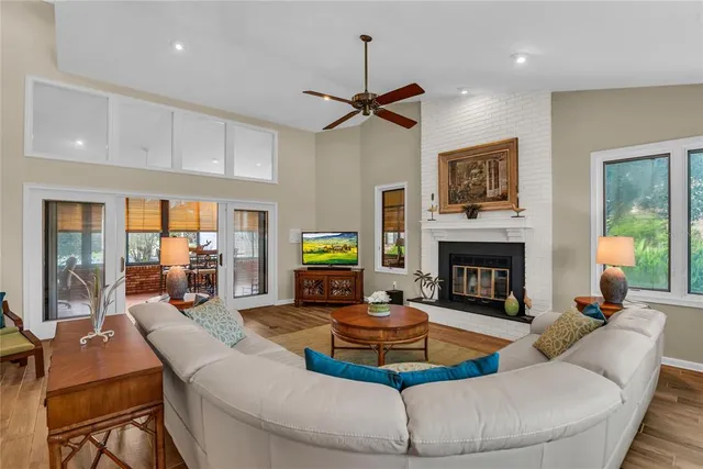 a large white kitchen with stainless steel appliances granite countertop a stove and a sink