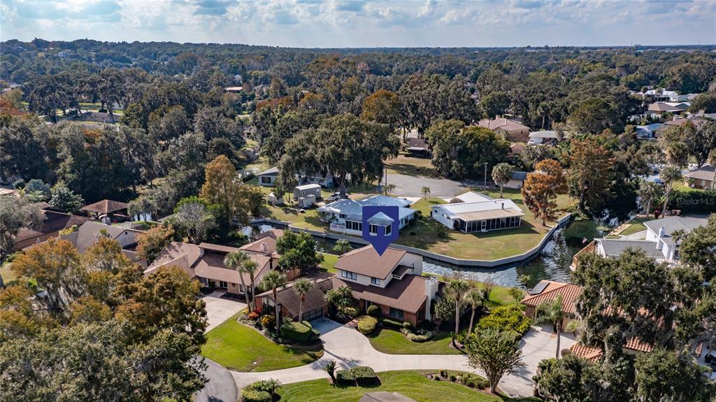 104 Acacia Point Yalaha, FL 34797 - Photo 76 of 83 an aerial view of a house with a swimming pool yard and outdoor seating