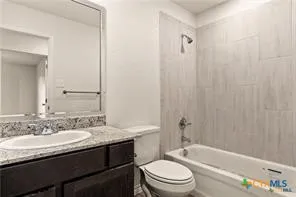 a bathroom with a granite countertop sink toilet a mirror and shower